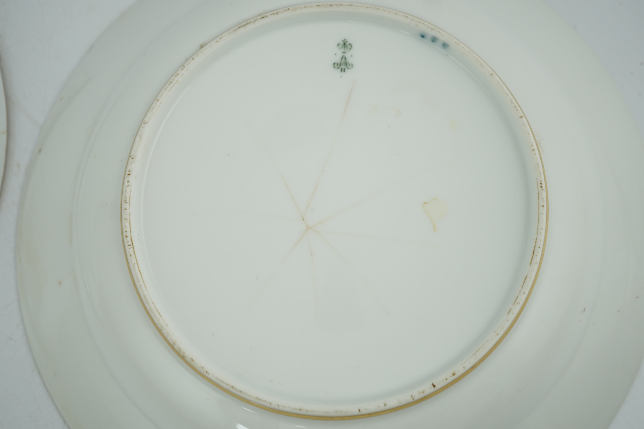 A pair of Nicholas II Imperial porcelain factory plates, from the Gothic service, green printed marks, 23.5cm diameter. Condition - poor to fair repairs
